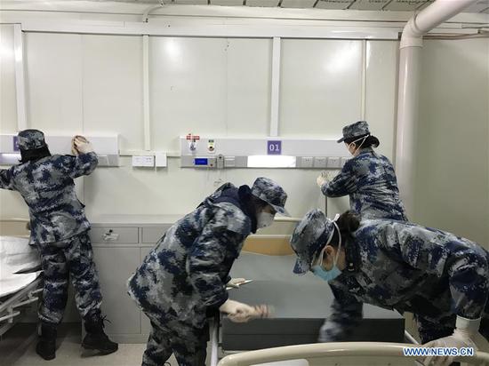 Medical staff test facilities and make the bed at Huoshenshan (Fire God Mountain) Hospital to make final preparations to admit patients infected with the novel coronavirus in Wuhan, central China's Hubei Province, Feb. 3, 2020. (Xinhua) 